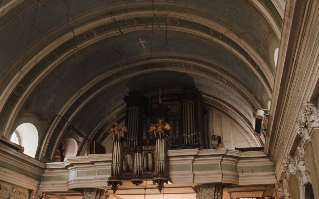 Intricate architectural details in a historic church, featuring ornate organ pipes.