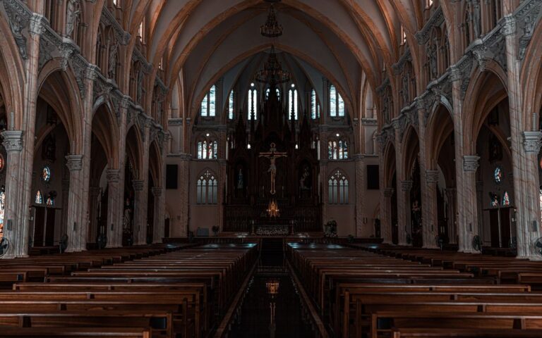 Beautiful view of a Gothic cathedral's interior with detailed arches and altar.