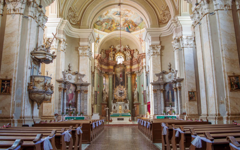 Capture of a beautiful Baroque church interior showcasing the grandeur of its altar and intricate architecture.