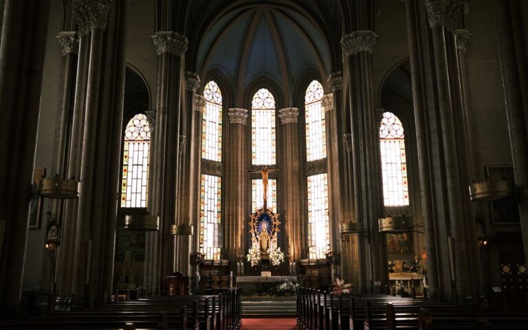 Inside view of St. Anthony of Padua Church showcasing its architecture, stained glass, and altar.